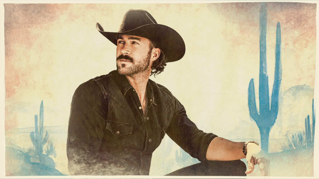 Country singer Riley Green wearing a cowboy hat, posing against a country backdrop.