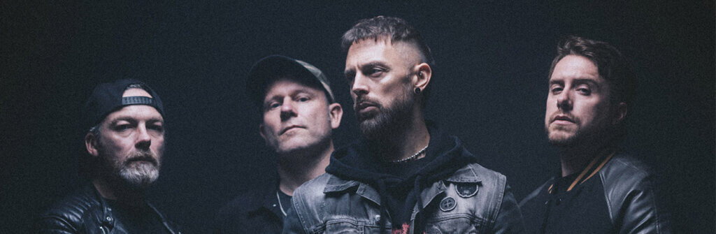 Bullet For My Valentine band members pose together against a plain black background.
