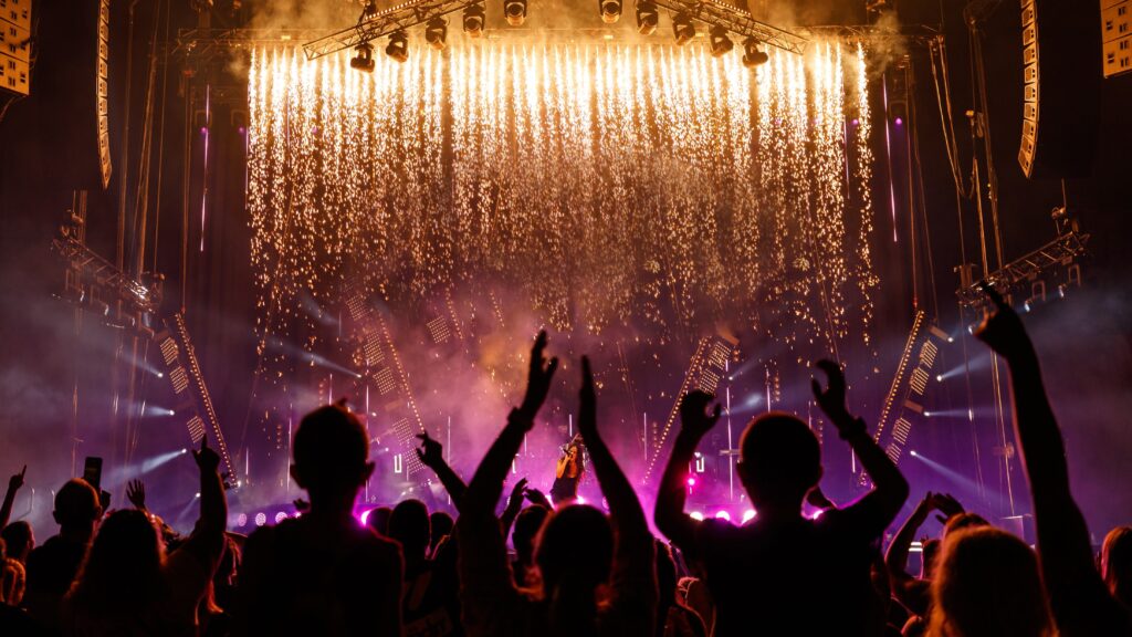 People dancing and enjoying a concert at Rod Laver Arena.