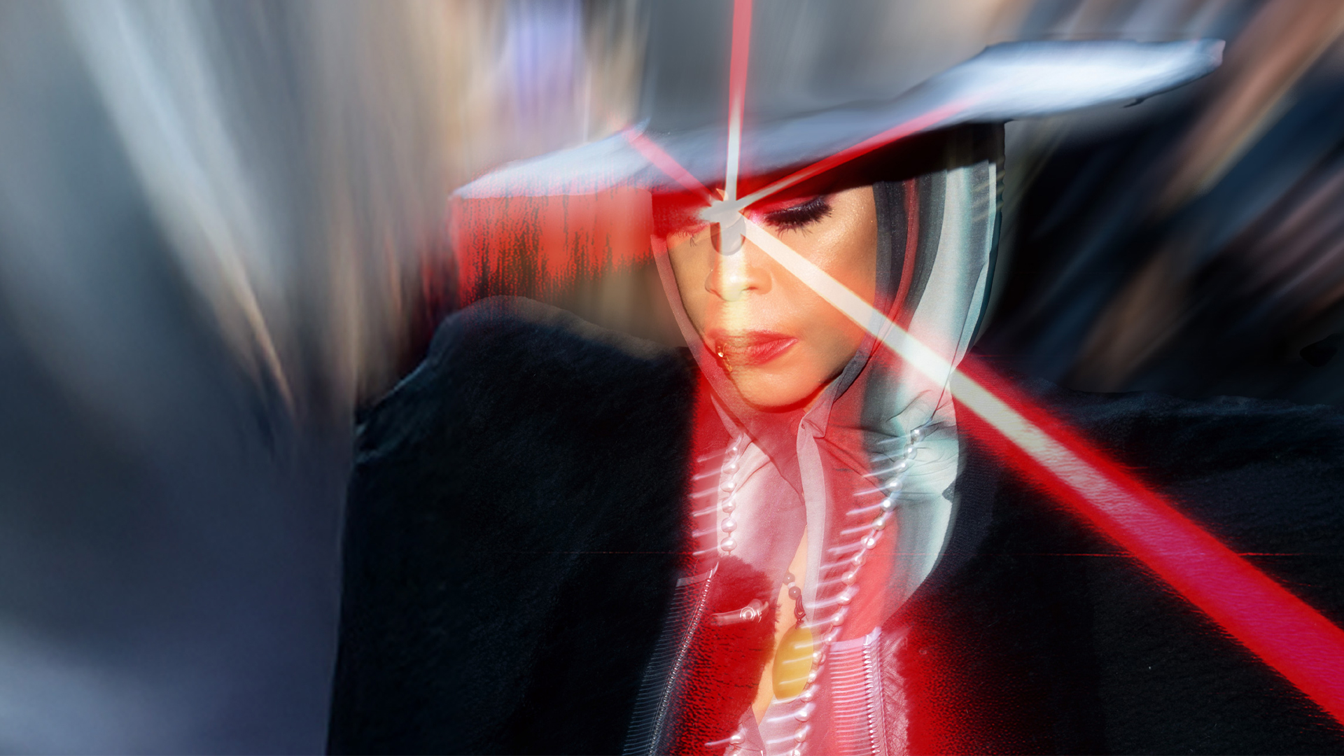 Singer Erykah Badu wearing a hat and posing with lasers.