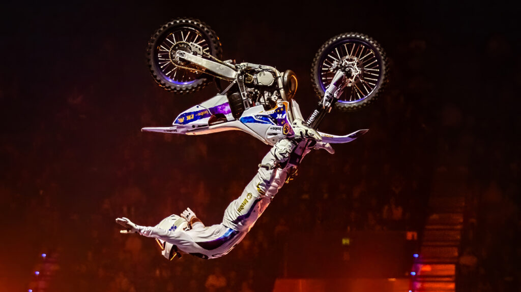 A motorcyclist executes a mid-air trick.