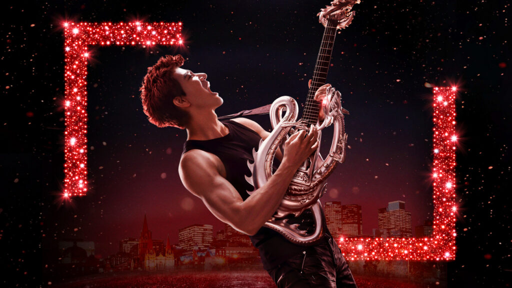 Leehom passionately plays an electric guitar within a striking red frame.