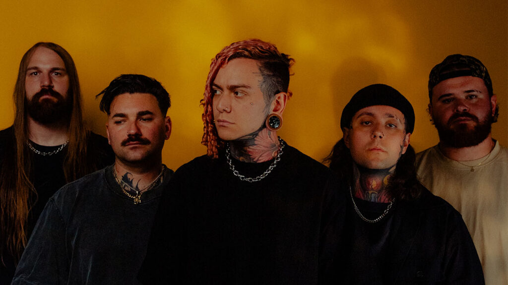 Lorna Shore band members band pose together in front of a solid black background.