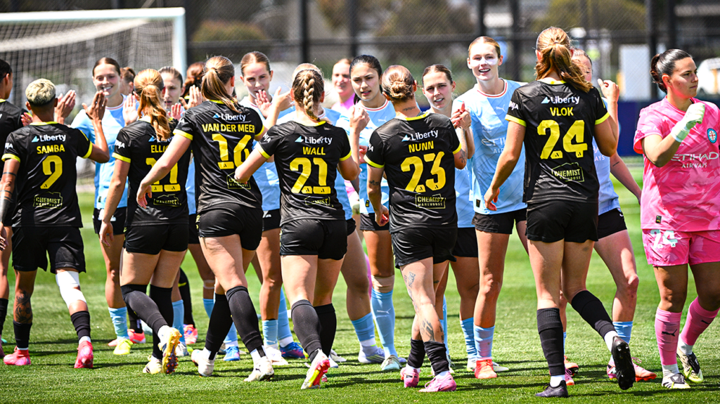 Melbourne City FC and Wellington Phoenix female footballers shaking hands.