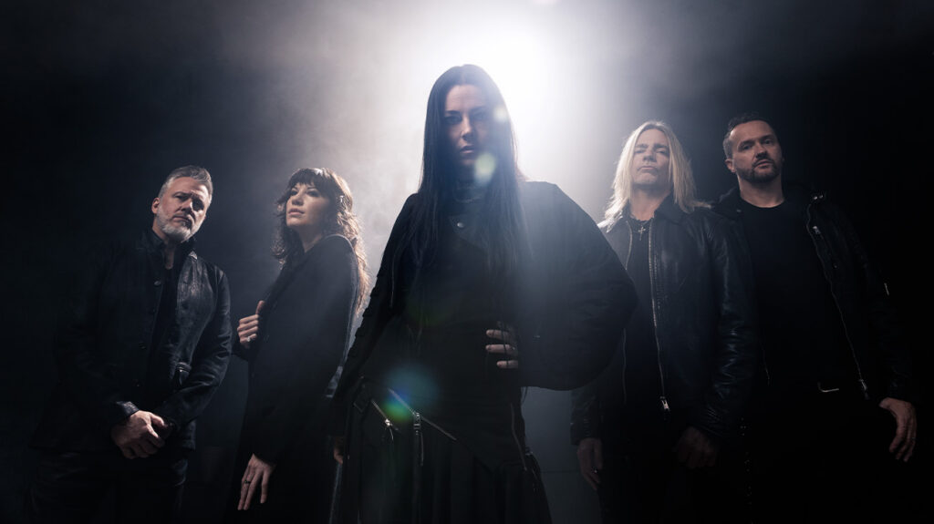 Evanescence band members stand together in front of a dark background.