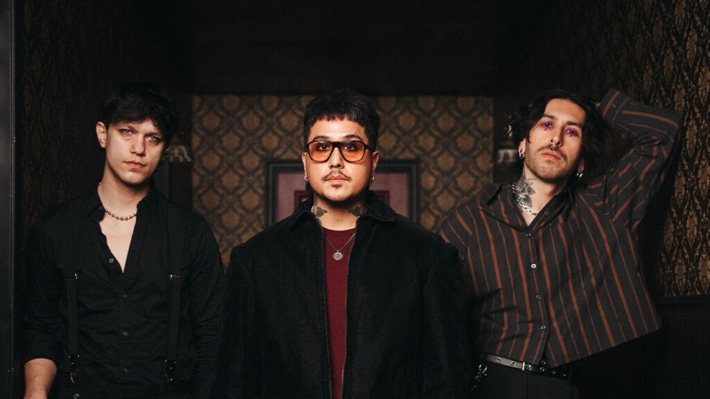 Dayseeker band members stand in a hallway and posing for the photo.