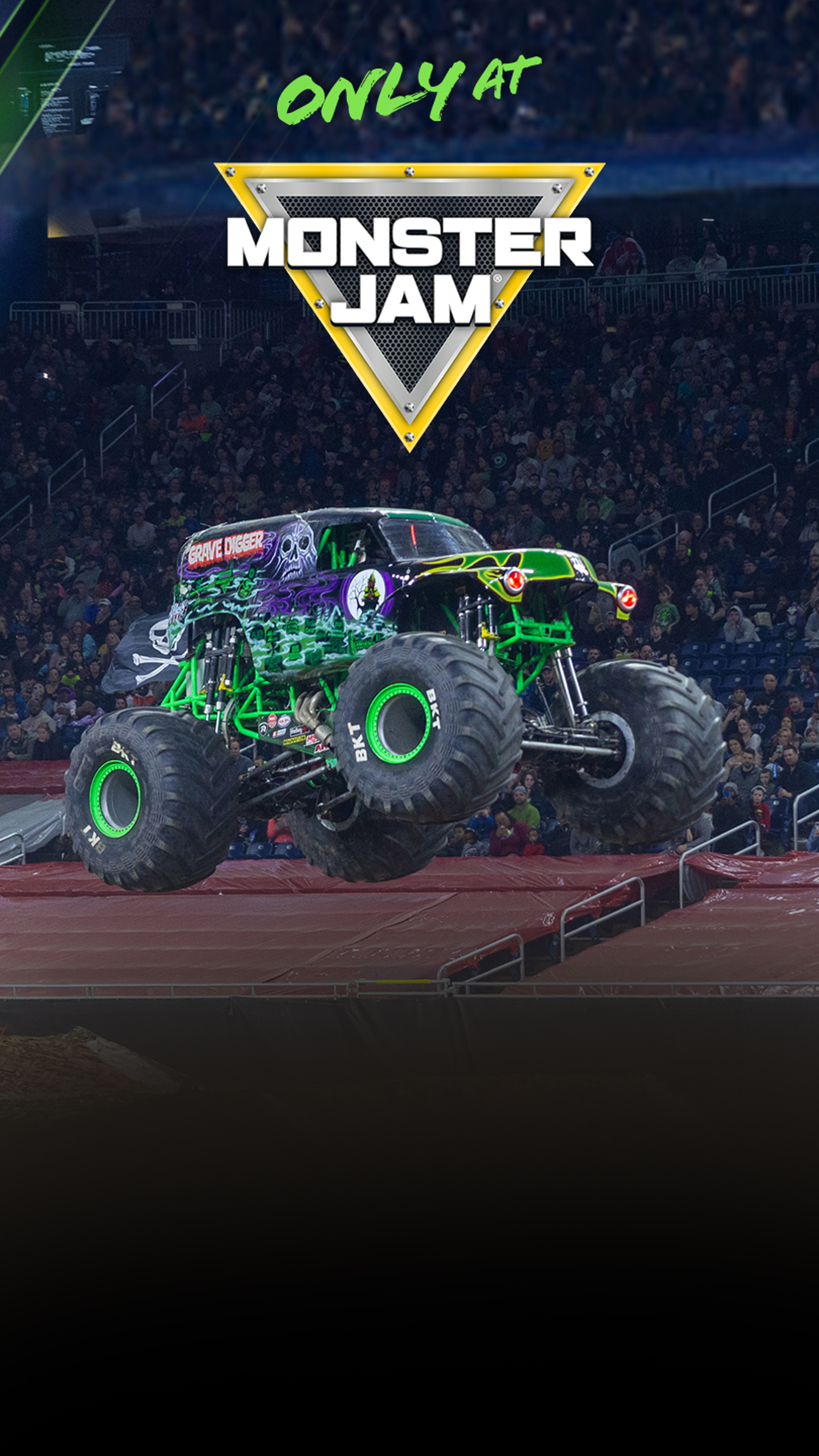 A monster truck soars above a cheering crowd during a motorsport event.