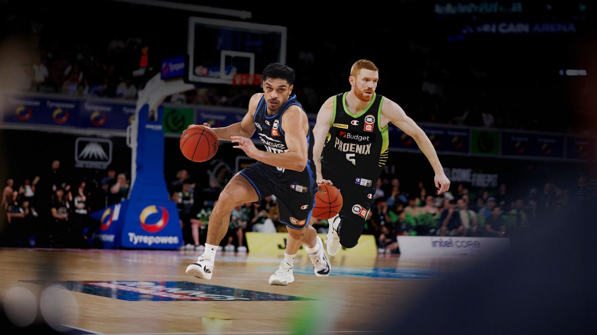 Melbourne United and South East Melbourne Phoenix basketballs in action on court.