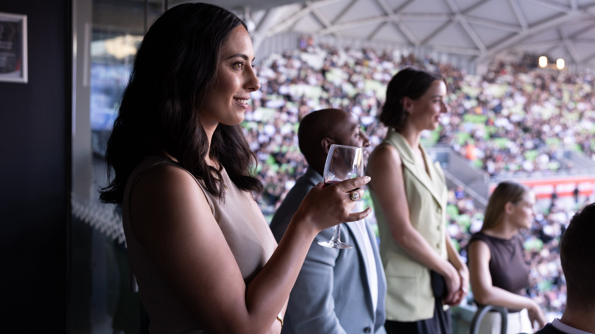 Woman enjoying a drink at a concert.