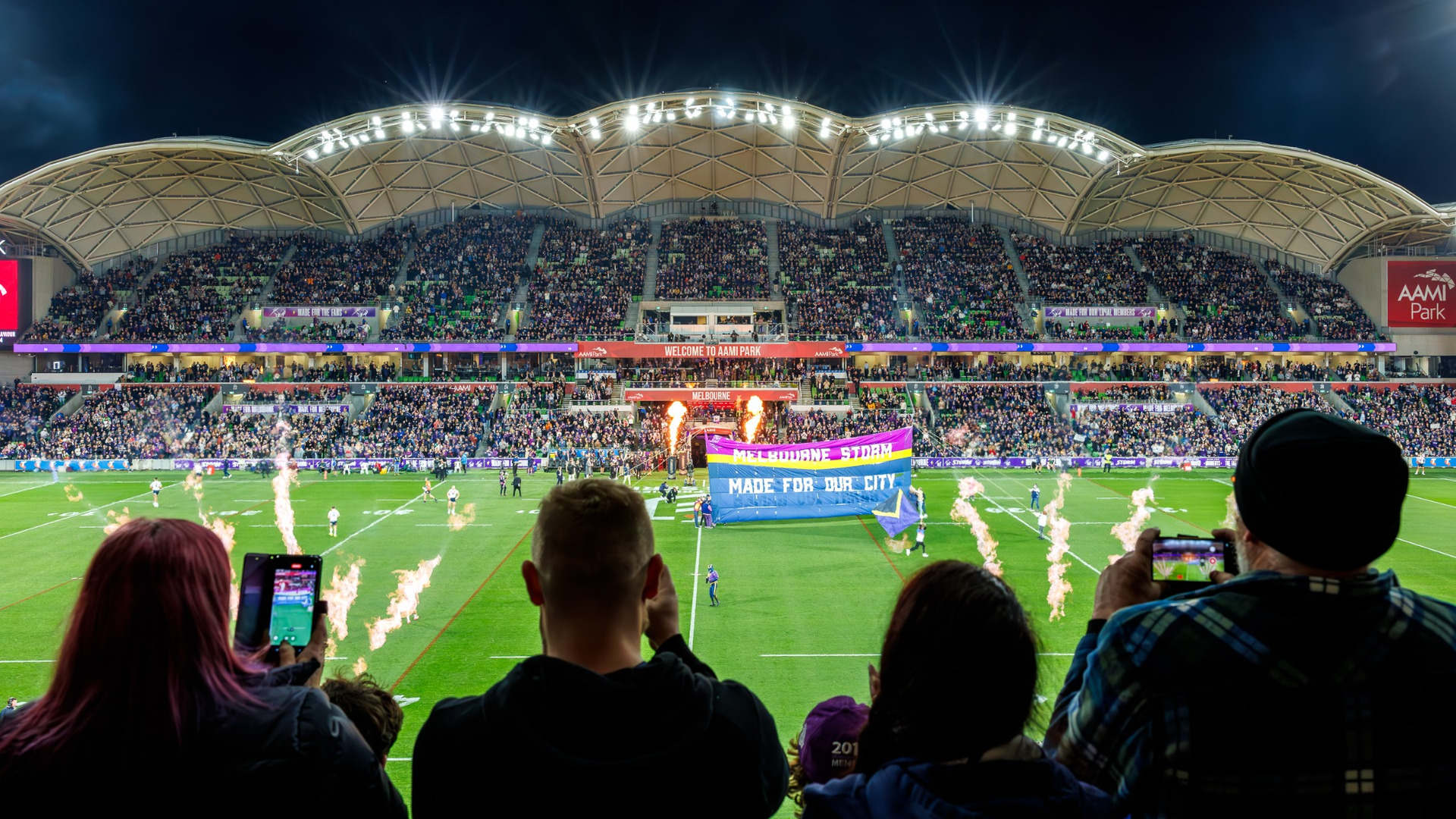 People watching on a packed crowd at a sporting event.